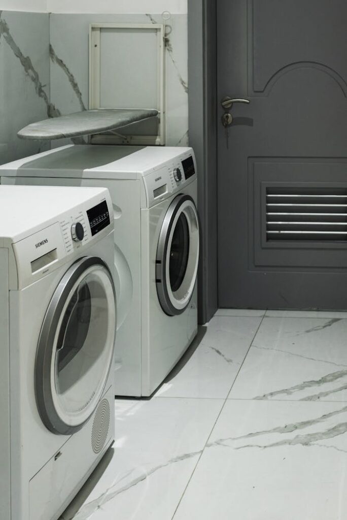 White Front Load Washing Machines in a Room